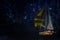 A sailboat sails under the starry sky. Space for text