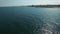 Sailboat at sea and coastline, aerial flight