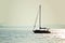 Sailboat silhouette on open water