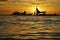 Sailboat Silhouetted Against A Setting Sun