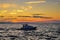 Sailboat silhouetted against the setting sun on a tranquil sea, Zadar, Croatia