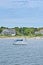 A sailboat sits patiently in a harbor in Cape Cod