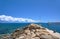 Sailboat at the stone breakwater in the harbor