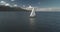 Sailboat sun reflection at seascape aerial. Racing yacht sail at open sea. Luxury ship at summer