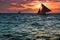 Sailboat sunset over the ocean water