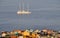 Sailboat traverses the ocean under the city of Sao Filipe