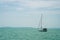 A sailboat is waiting in day stillness under beautiful blue sky with clouds on Lake Balaton, Hungary. Mountains on background. Yac