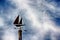 Sailboat weathervane in the sky