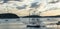 Sailboats docked on pier in early morning under cloud cover in Bar Harbor Maine