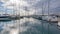 sailboats in a marina. Reflection in water the passing of clouds
