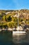 Sailboats moored at the rocky coast of Croatia. Evening bay on the island of Hvar. Relax in the sea. Ships at sunset. Holidays on