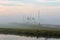 Sailboats and motor yachts moored in a foggy harbor in Warmond