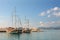 Sailboats on pier. Calm sea water and blue sky background