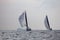 Sailboats sail in windy weather in the blue waters of the Aegean Sea