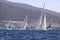 Sailboats sail in windy weather in the blue waters of the Aegean Sea