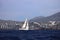 Sailboats sail in windy weather in the blue waters of the Aegean Sea