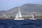 Sailboats sail in windy weather in the blue waters of the Aegean Sea