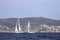 Sailboats sail in windy weather in the blue waters of the Aegean Sea