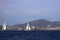 Sailboats sail in windy weather in the blue waters of the Aegean Sea