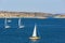 Sailboats sailing in rocky sea archipelago