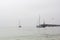 Sailboats in the sea on foggy day