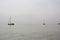 Sailboats in the sea on foggy day