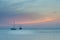 Sailboats on sea navigating under the sunset