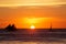 Sailboats at sunset on a tropical sea. Silhouette photo.