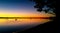 Sailboats in the sunset - view toward Bribie Island Bridge over the Pumicestone Passage with Glasshouse mountains on horizon