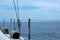 Sailing in Aegean Sea, Greece. Sailboat fender and rope on the deck, cloudy sky