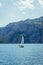 Sailing as a passion: Sailing boat with clear water and mountain landscape