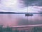 Sailing boat anchoring next to a buoy in the calm water of lake