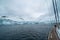 Sailing boat in Antarctica, yacht navigation through icebergs and sea ice