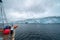 Sailing boat in Antarctica, yacht navigation through icebergs and sea ice
