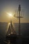 Sailing boat and beacon and sunset