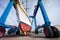 Sailing boat in boatyard on a crane