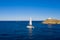 Sailing boat catamaran with white sails, rippled sea background