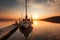 sailing boat docked at sunset with a tranquil, serene atmosphere