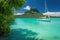 sailing boat moored in tranquil lagoon against tropical backdrop