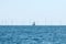 A sailing boat passes near the Rampion offshore wind farm off the south coast of England, UK