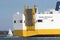 Sailing boat passing a vehicles carrier ship on Southampton Water UK