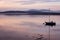 Sailing boat reflecting in calm waters