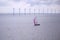 Sailing boat in a sea. Windmills in the sea. Yacht sailing in ocean. Sailing vessel.......