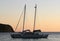 A sailing boat in Vathi bay at sunset, Sifnos island, Greece.