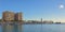 Sailing boats in front of big apartment buildings and lighttower in the port of Malaga, Spain