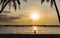 Sailing boats and silhouette of couple over a beautiful sunset