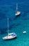 Sailing boats and swimmers at Punta Negra on Elba island, Italy