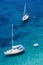 Sailing boats and swimmers at Punta Negra on Elba island, Italy