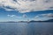 Sailing boats on water with lefkas shore mountains and clouds bl