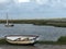 Sailing boats on the waters edge Brancaster east coast England at low tide